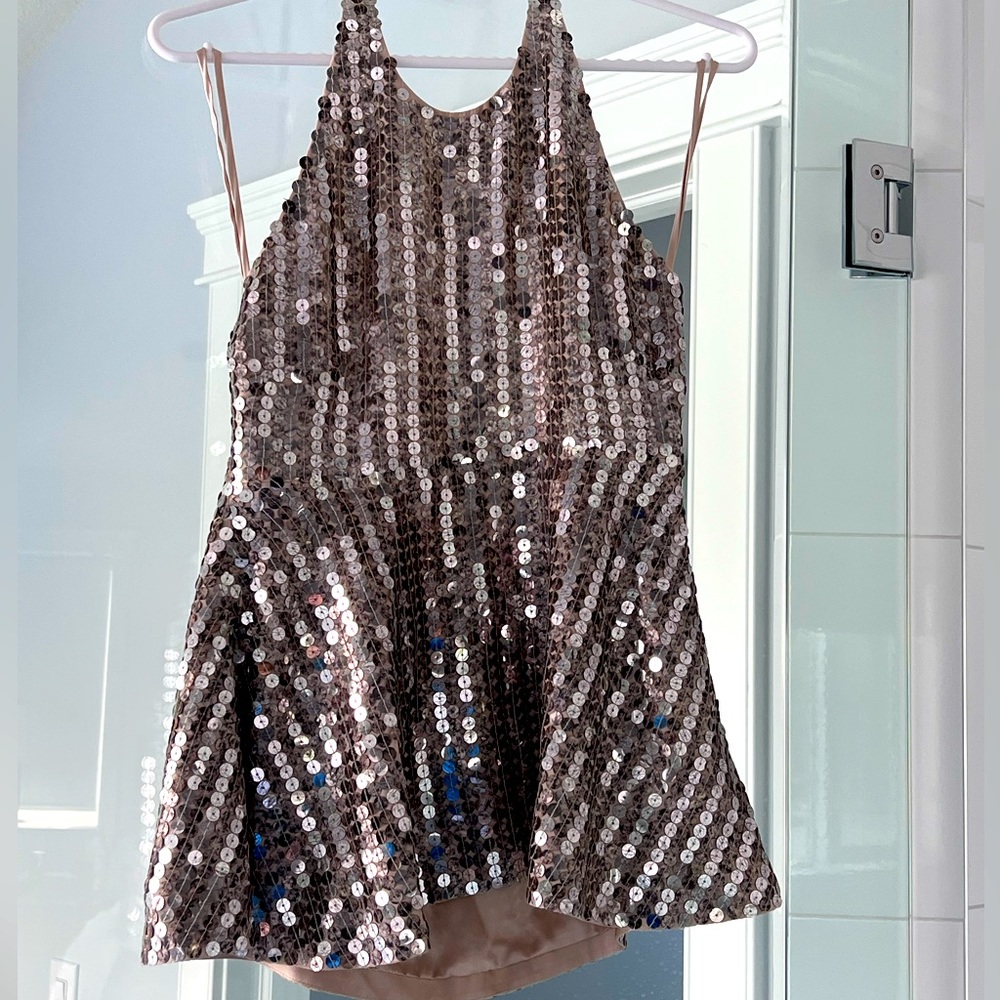 Sleeveless sequin open back top.  Perfect for a night out